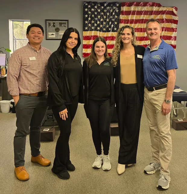 The Fort Walton Beach Chiropractic team, including Dr. Scott Smith and Dr. Francis Martin, at the clinic